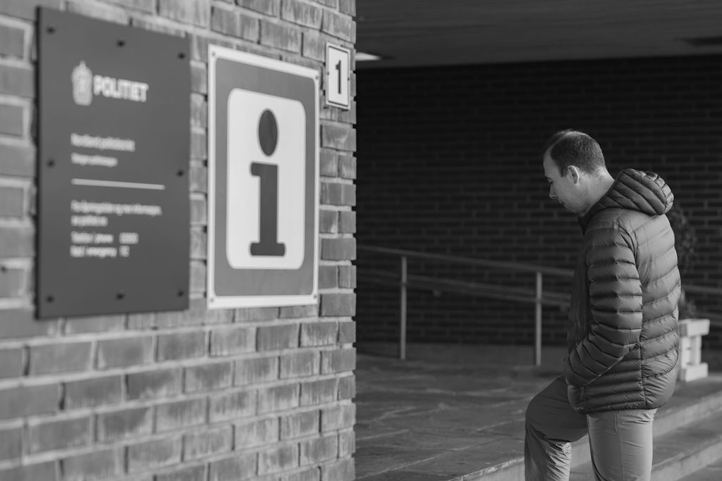 man entering the local police office in order to apply for a renewed residence permit